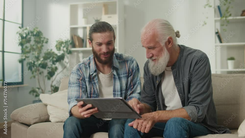 Young volunteer teaches senior how to use a tablet, bridging generation gap, tech-savvy youth, elderly learning, digital literacy, cross-age friendship, modern gadgets Young volunteer teaches senior how to use a tablet, bridging generation gap, tech-savvy youth, elderly learning, digital literacy, cross-age friendship, modern gadgets