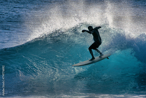 Silhouette of surfer at Makaha Beach Oahu Hawaii photo