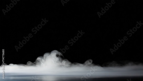 a cloud of white smoke on a black background thin smoke some areas of which seem thicker than others  thick fog that expands over the surface photo