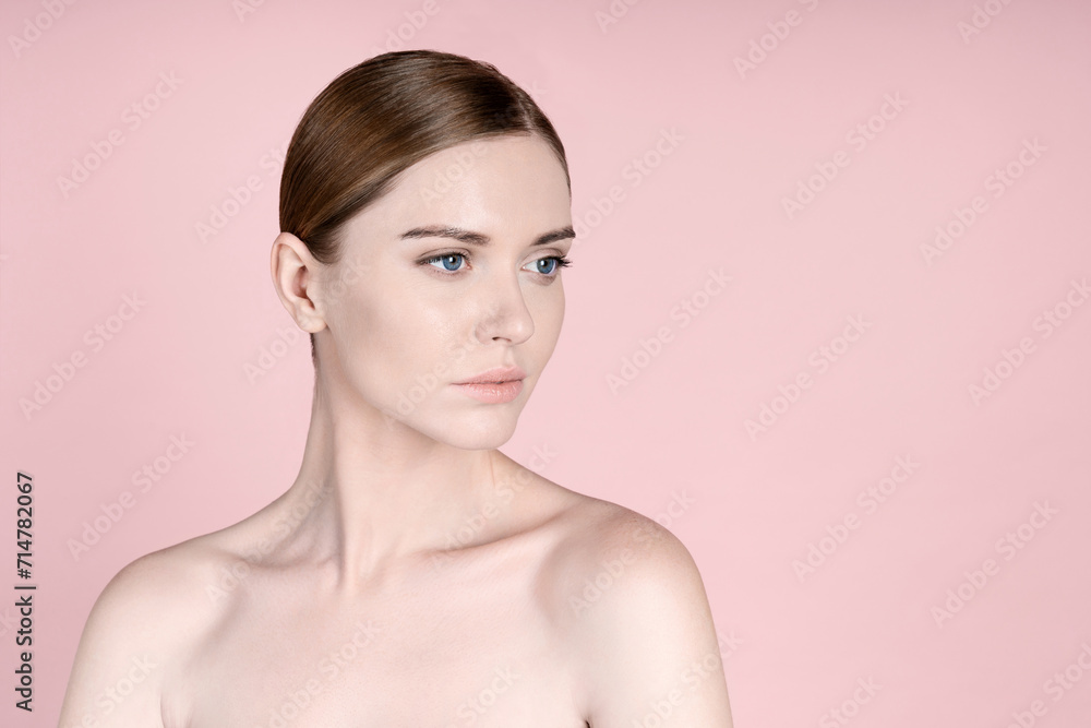 Gorgeous red hair woman with blue eyes, clear glowing skin, perfect shiny body after spa effect, doing nourishing skincare routine at home, standing over pink pastel background. Copy space Gorgeous red hair woman with blue eyes, clear glowing skin, perfect shiny body after spa effect, doing nourishing skincare routine at home, standing over pink pastel background. Copy space