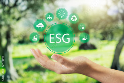 Social investment business concept. ESG and environmental governance, human hand holding green ESG icon, sustainable global clean energy, sustainable and ethical corporate development.