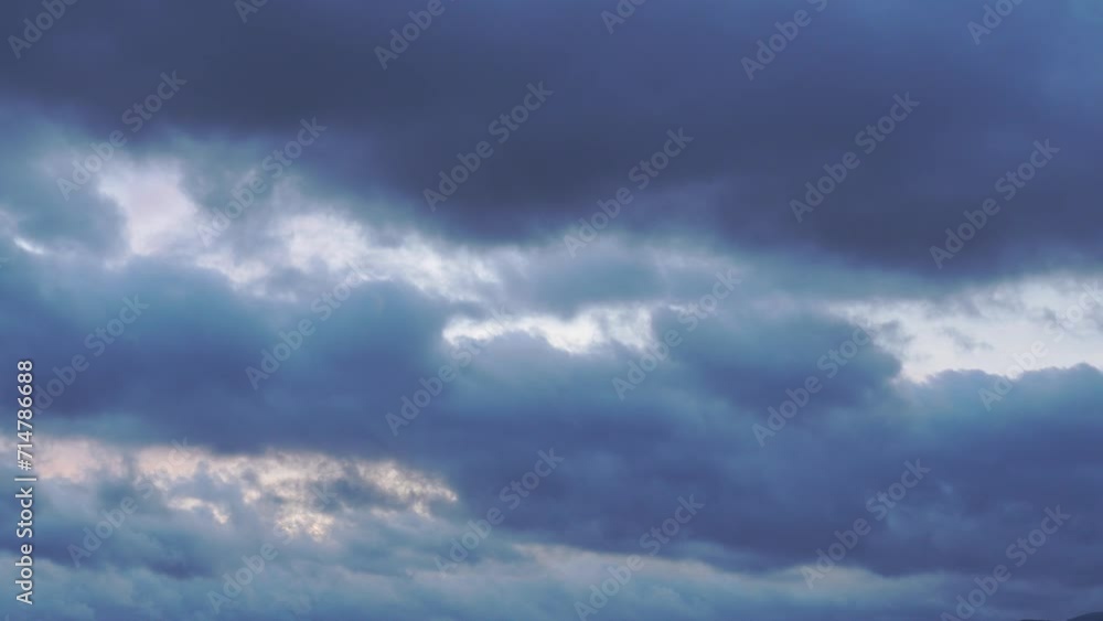 4K Time lapse, beautiful sky with dark blue clouds background. Sky with clouds. Rays of the sun shine through the clouds. 4K Time lapse, beautiful sky with dark blue clouds background. Sky with clouds. Rays of the sun shine through the clouds.