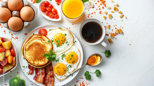 Fresh and delicious healthy breakfast spread on a white table, featuring eggs, bacon, bread, cheese, and fruit