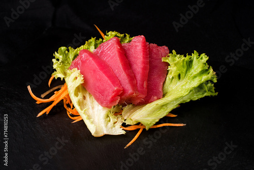 salmon fillet on a leaf of green salad photo