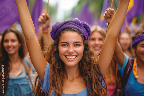Group of women at a feminist march on Women's Day, raising fists for the fight for rights and equality, purple flags, and smiles