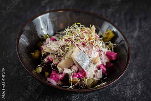 herring salad with baked beets and pickled cucumber photo