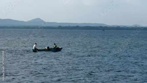 fishermen ride boat on the lake photo