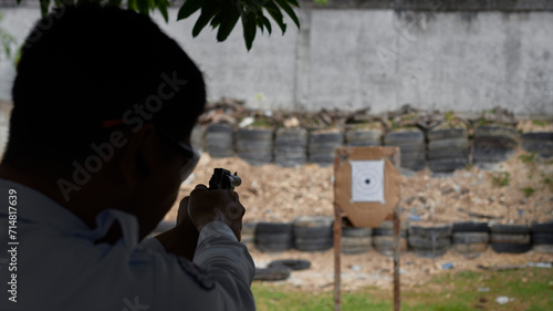 silhouette of a man with a gun, target practice, blurred focus