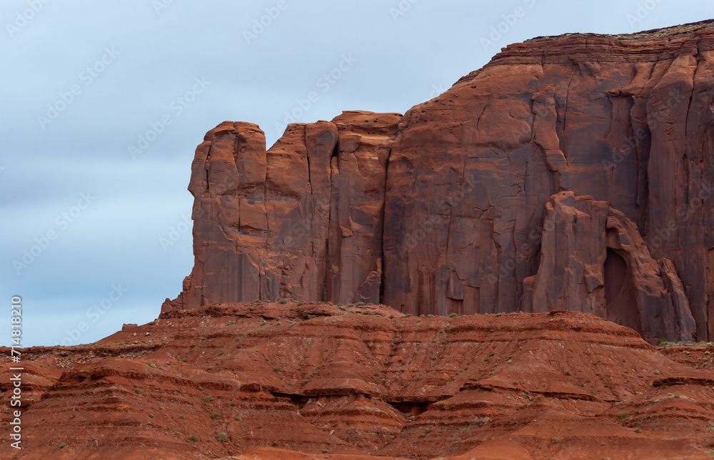 Desert landscape with red rocks and dry vegetation on red sands in Monument Valley, Navajo Nation, Arizona - Utah Desert landscape with red rocks and dry vegetation on red sands in Monument Valley, Navajo Nation, Arizona - Utah