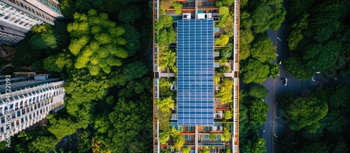 Roof of apartment building with solar panels seen from above. photo
