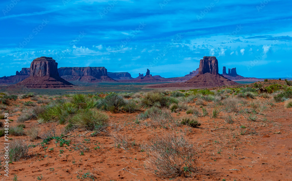 Arizona landscape, red eroded sandstone cliffs and Sand dunes desert of Monument Valley