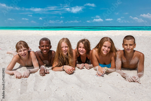 Cheerful group of children on the sandy beach