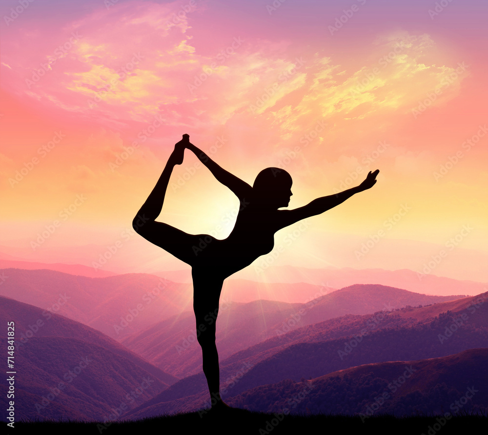 A woman practices yoga on background of mountains and sky. Healthy lifestyle concept.
