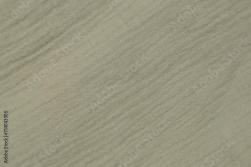 Soft Muslin Detailed Texture. Natural Cotton Fabric Closeup Pattern. Khaki Green Light Chintz Surface. Rotation, Macro. Cozy Textile Background. Clothes Production. Melange Yarn. 4K Shot