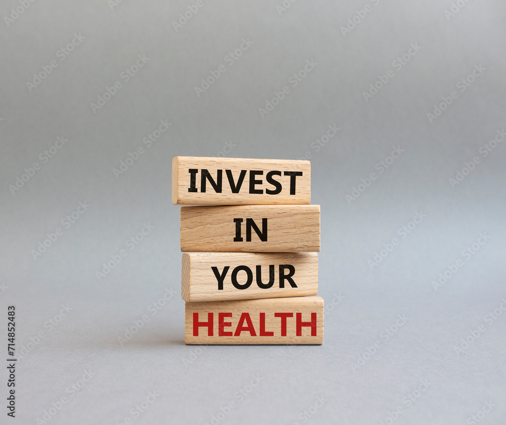 Invest in your Health symbol. Concept words Invest in your Health on wooden blocks. Beautiful grey background. Business and Invest in your Health concept. Copy space. Invest in your Health symbol. Concept words Invest in your Health on wooden blocks. Beautiful grey background. Business and Invest in your Health concept. Copy space.