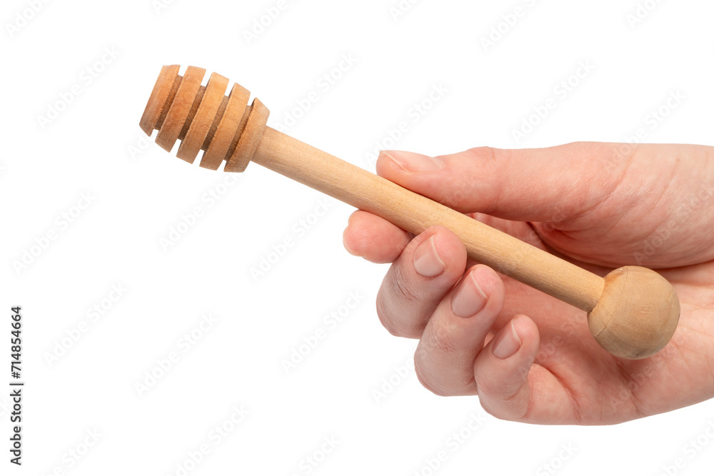 Honey dipper in woman hand isolated on a white background. Honey dipper in woman hand isolated on a white background.