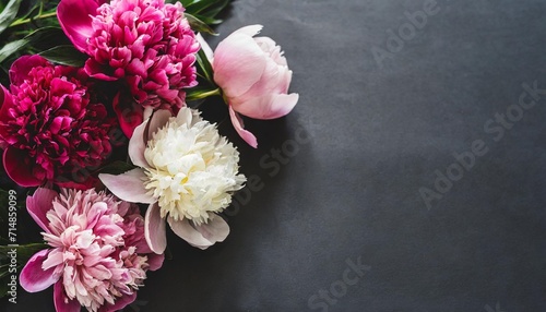beautiful bouquet of pink and white peonies on a black background with place for text minimalistic composition in a dark key flat lay moody floral copy space