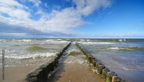 baltic sea blue sky wave sea and wooden waterbreak