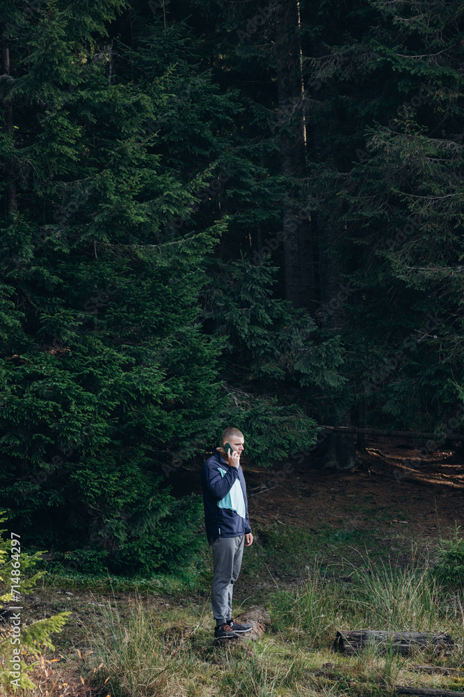 Fototapeta premium Going the distance. Shot of a young man enjoying a hike through the mountains. a handsome man with an athletic build is traveling in the mountains. landscape 