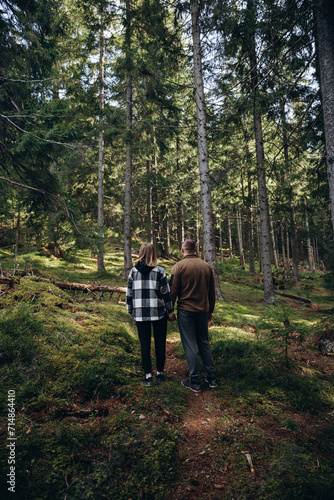 family young couple in the mountains, autumn forest. a man and a woman went to the mountains. clothes and shoes for trekking. Man and a woman went on a mountain trip. CARPATHIAN MOUNTAINS