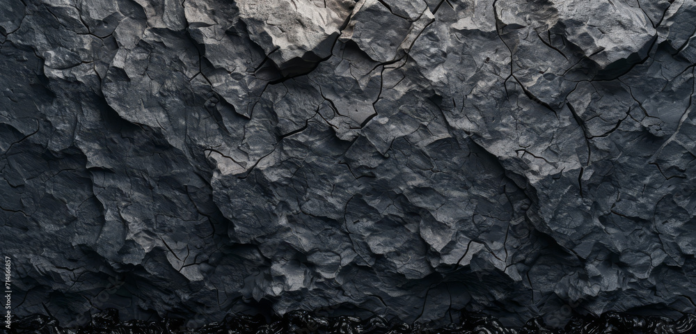 Rugged black abstract geometric shapes with a stone-like texture on a dark base. Rugged black abstract geometric shapes with a stone-like texture on a dark base.