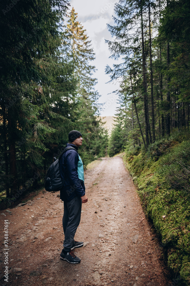 Going the distance. Shot of a young man enjoying a hike through the mountains. a handsome man with an athletic build is traveling in the mountains. landscape 
