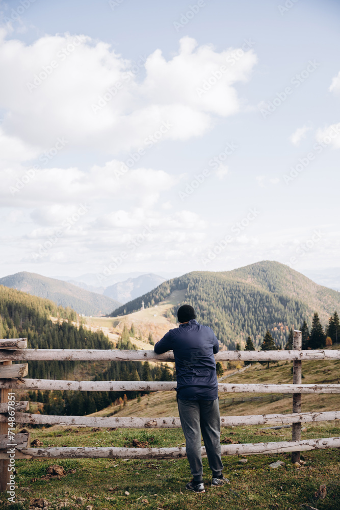 Naklejka premium Going the distance. Shot of a young man enjoying a hike through the mountains. a handsome man with an athletic build is traveling in the mountains. landscape 