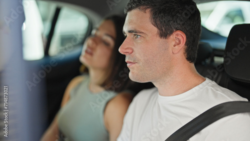 Beautiful couple passengers sitting on car at street © Krakenimages.com