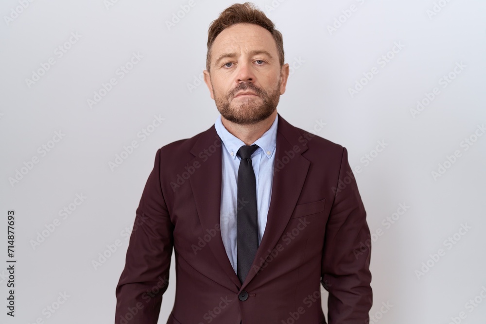Middle age business man with beard wearing suit and tie relaxed with serious expression on face. simple and natural looking at the camera. Middle age business man with beard wearing suit and tie relaxed with serious expression on face. simple and natural looking at the camera.