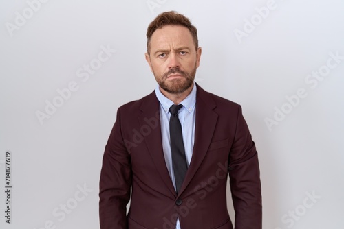 Middle age business man with beard wearing suit and tie depressed and worry for distress, crying angry and afraid. sad expression.