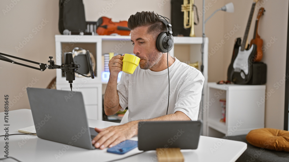 Attractive young hispanic man, a professional reporter, passionately speaking on air in a cozy radio studio, holding a cup of coffee Attractive young hispanic man, a professional reporter, passionately speaking on air in a cozy radio studio, holding a cup of coffee