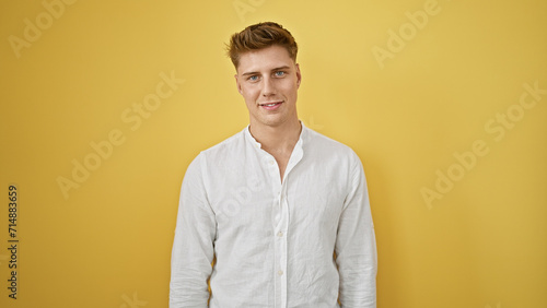 Laughing, confident young caucasian man in casual fashion, standing isolated against a yellow background, radiating positive vibes and joy © Krakenimages.com