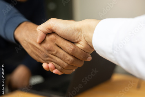 close up group manager hand reach to handshake with businessman after finish meeting about dealing marketing plan project and investment in office room for excellence experience concept