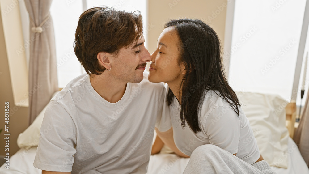 Interracial couple in love sharing a moment in a cozy bedroom setting, reflecting diversity and intimacy. Interracial couple in love sharing a moment in a cozy bedroom setting, reflecting diversity and intimacy.