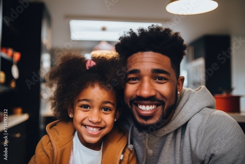 Smiling portrait of a young father and daughter