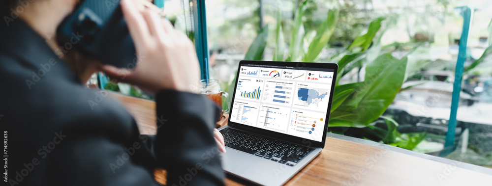 Businessman works on laptop showing business analytics dashboard with ...