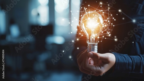 Businessman hand holding creative light bulb with industry network, analysis solution and development marketing network icons planning strategy, Modern business, Innovative of new ideas photo