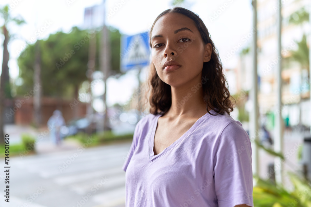 Young african american woman standing with serious expression at street Young african american woman standing with serious expression at street