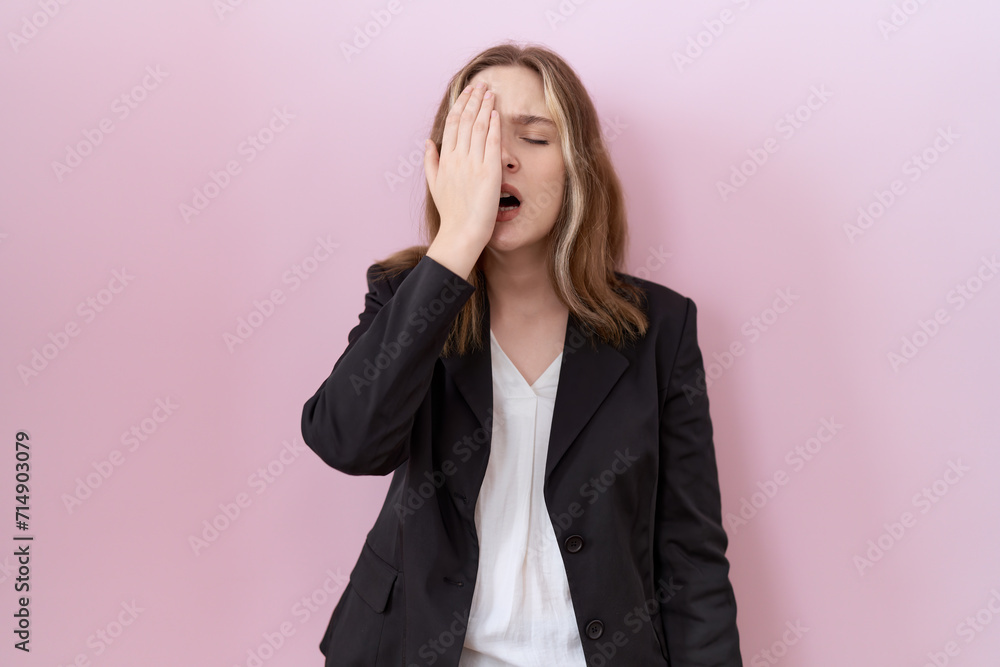 Young caucasian business woman wearing black jacket yawning tired covering half face, eye and mouth with hand. face hurts in pain. Young caucasian business woman wearing black jacket yawning tired covering half face, eye and mouth with hand. face hurts in pain.