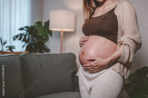 mother, family, maternity, pregnant, woman, pregnancy, baby, motherhood, love, happiness. pregnancy, motherhood, people, close up of happy pregnant woman with big belly near stand sofa and smiling. Free Download mother, family, maternity, pregnant, woman, pregnancy, baby, motherhood, love, happiness. pregnancy, motherhood, people, close up of happy pregnant woman with big belly near stand sofa and smiling. - GFXLoad