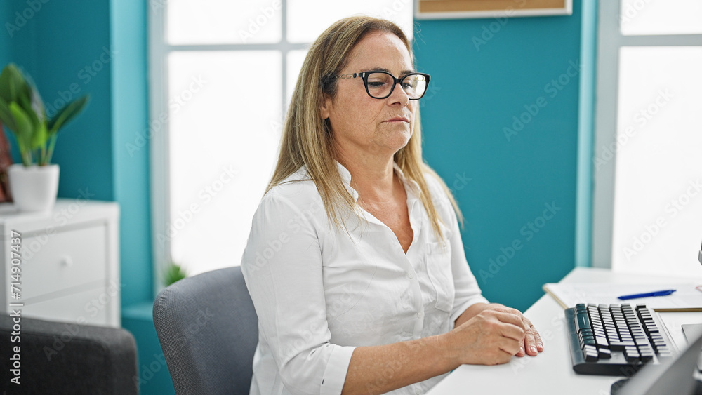 Middle age hispanic woman business worker using computer working at the office Middle age hispanic woman business worker using computer working at the office