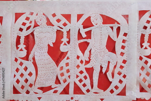 Northern thai style color paper-cut pattern in white on the red background photo