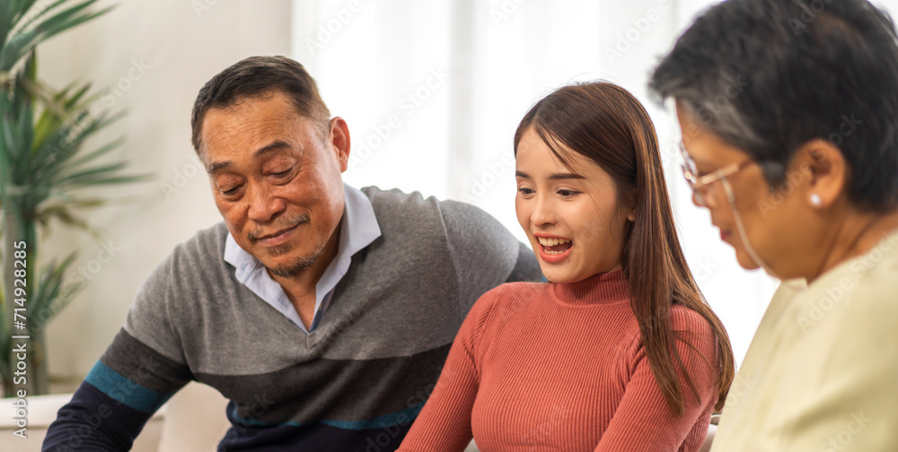 Portrait enjoy happy smiling love asian family.Senior mature father hug with elderly mother and young adult woman play laughing and having fun together at home.insurance concept