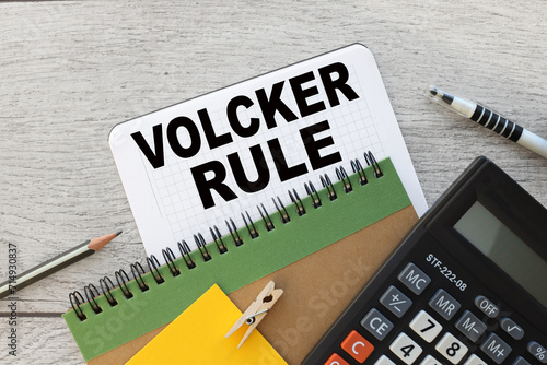 VOLCKER RULE notepad with spring with text. wood background photo