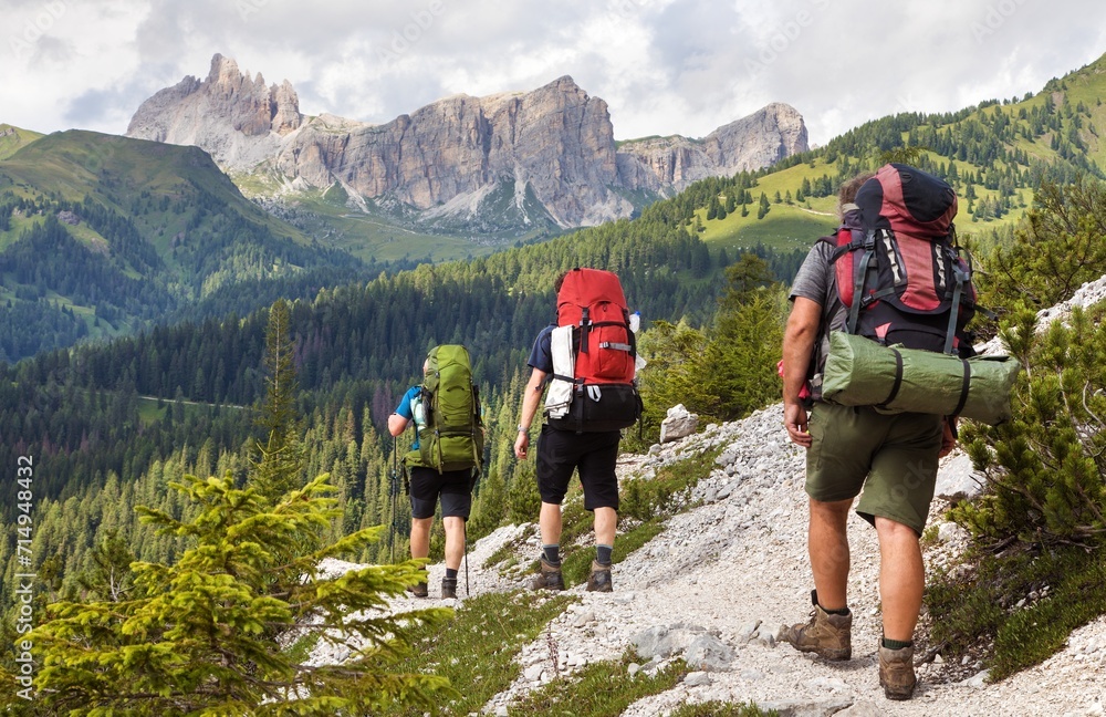 Group of hikers and Alps Dolomites mountains, Italy