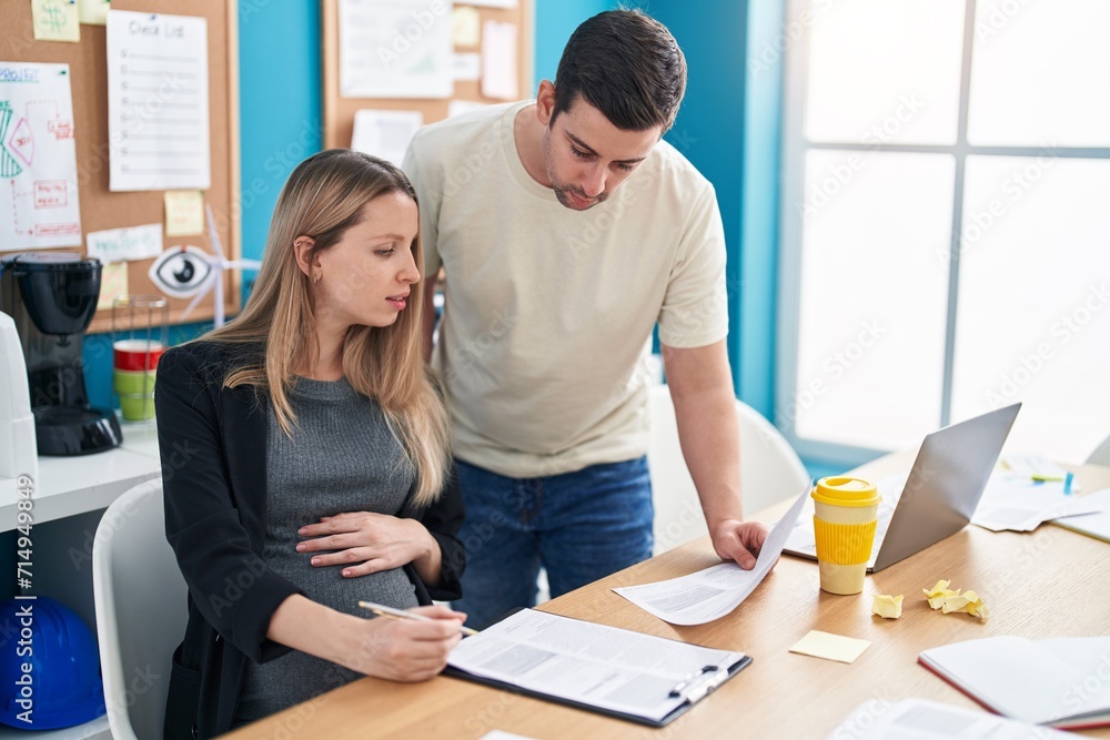 Man and woman business workers reading document working at office Man and woman business workers reading document working at office