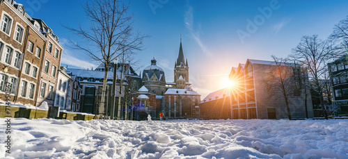 The famous Huge gothic cathedral of The Emperor Karl in Aachen Germany during winter season with snow at Katschhof against blue sky and sunshine background