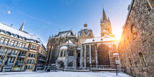 The famous Huge gothic cathedral of The Emperor Karl in Aachen Germany during winter season with snow at Katschhof against blue sky and sunshine background photo