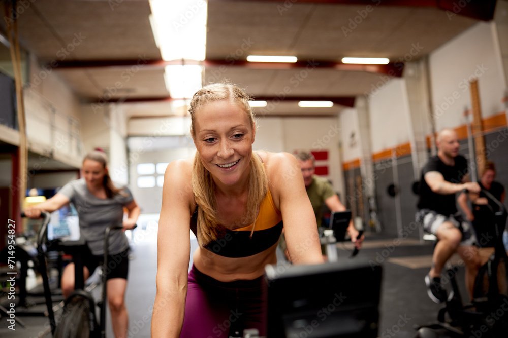 Woman smiling on a stationary bike Woman smiling on a stationary bike