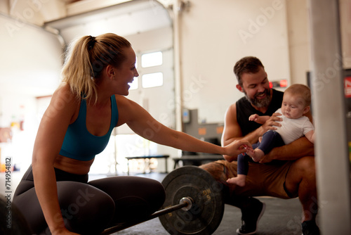 Smiling woman lifting weights with her family photo